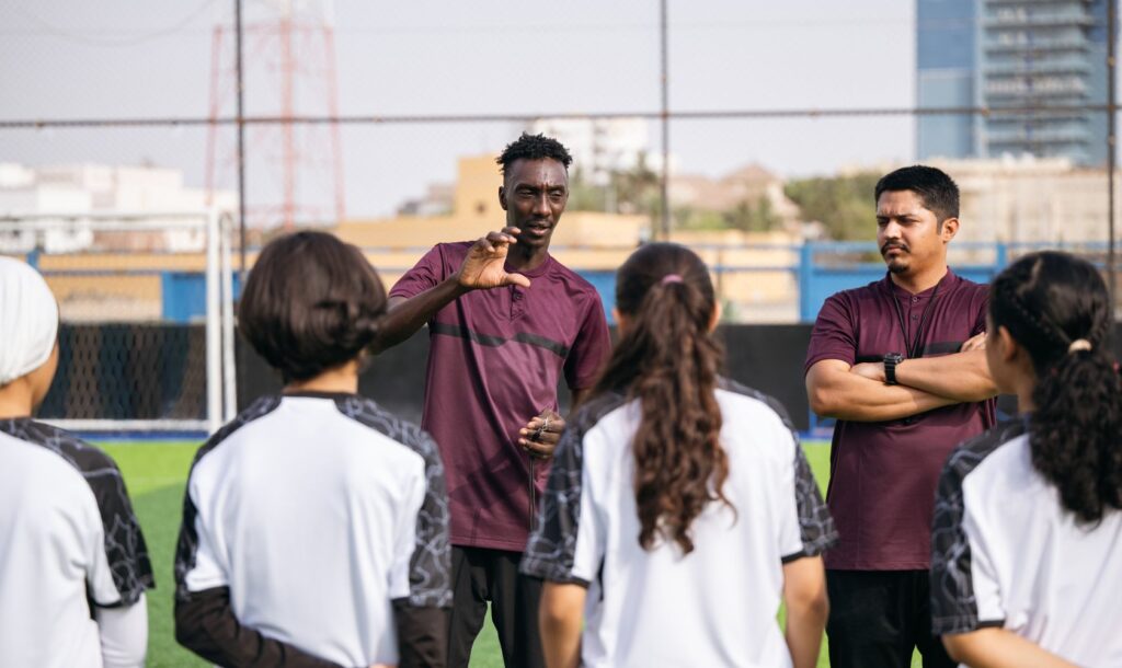 A soccer coach talks to his team.