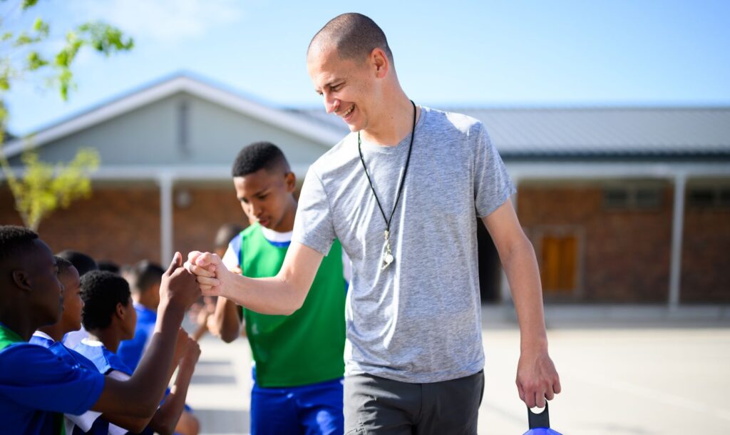 Coach shakes hands with the his players.