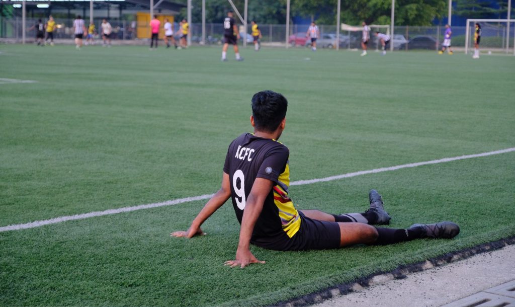 A player looks on from the sidelines.