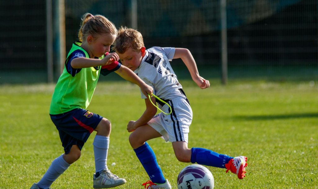 Young boys play soccer.